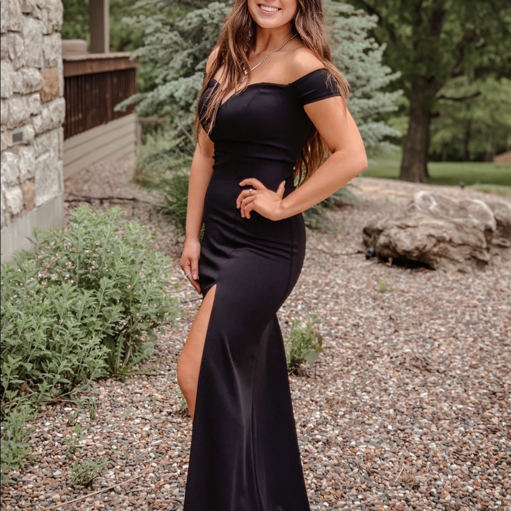 Black fitted off-shoulder dress with slit